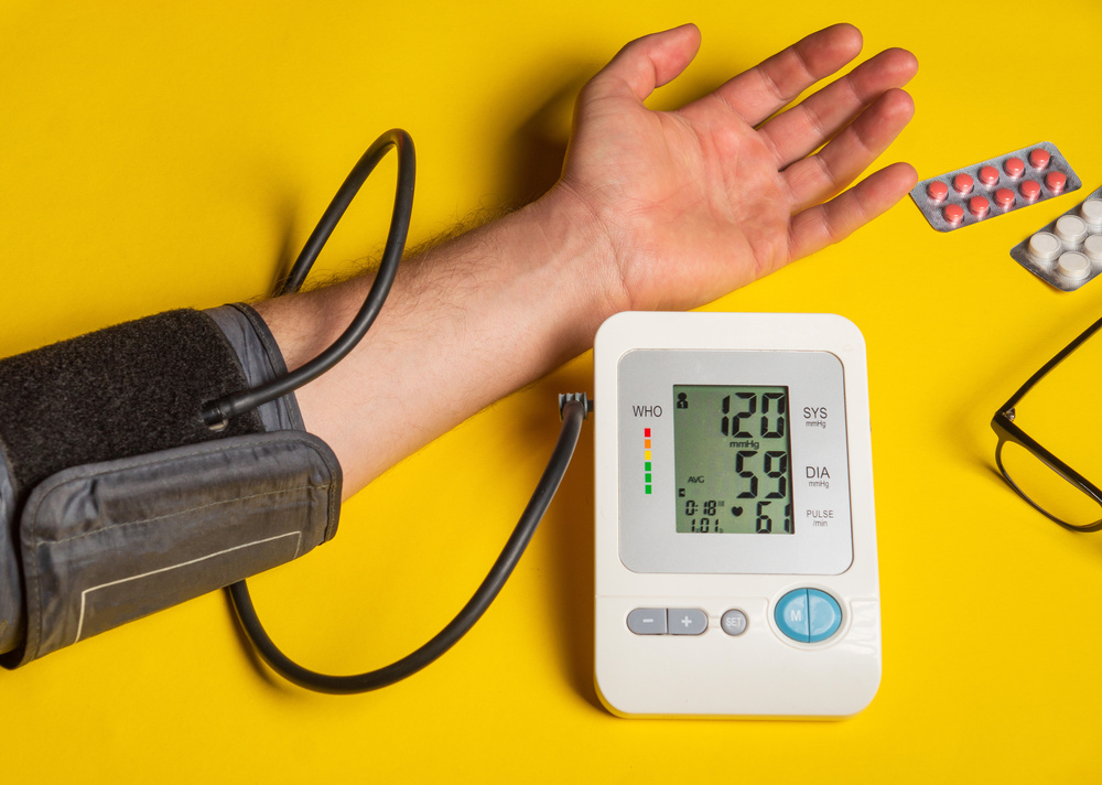 Person measures their own blood pressure at the yellow medical t